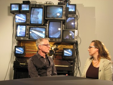 MoMA Educator Deborah Howes interviewing MoMA Conservator Glen Wharton in front of 'Untitled,' 1993 by Nam June Paik. Photo used with permission (c) MoMA 2013.