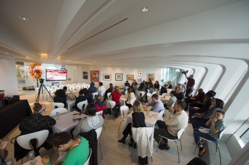 Friends, family, and teachers of the Satellite interns watch their final project videos at the program celebration. Photo by Front Room Photography