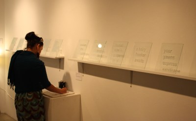  Visitor participating with Kristen Cochran's "Notes to self" from the exhibition [IN]Translation ARTIST WEBSITE:  http://kristencochran.com/home.html 