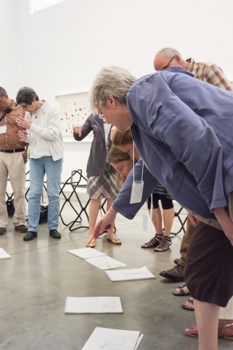 teachers looking at the drawings on the floor