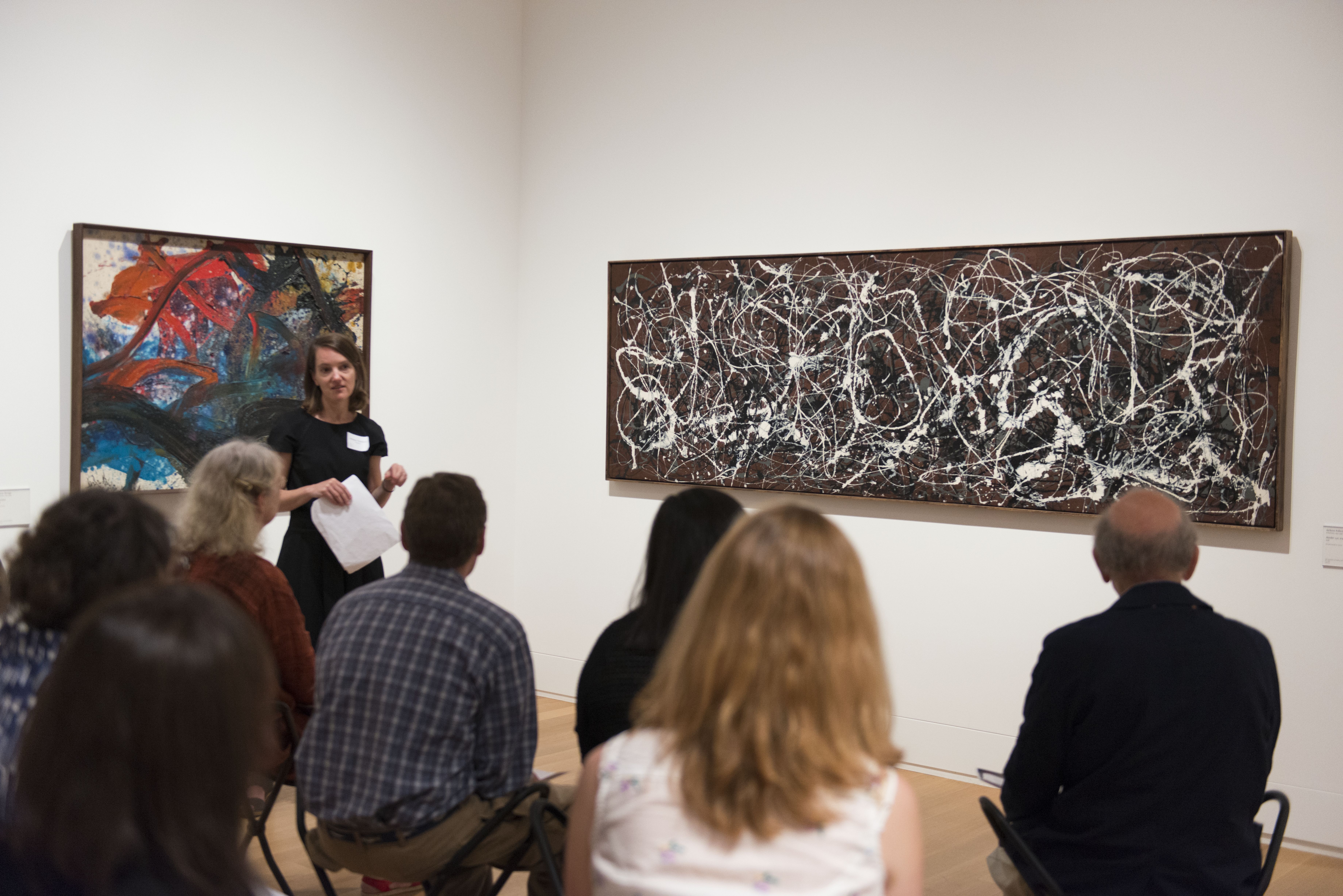 Molleen Theodore, Associate Curator of Programs, leads staff in a listening and looking exercise in front of Jackson Pollock’s Arabesque (number 13a.)